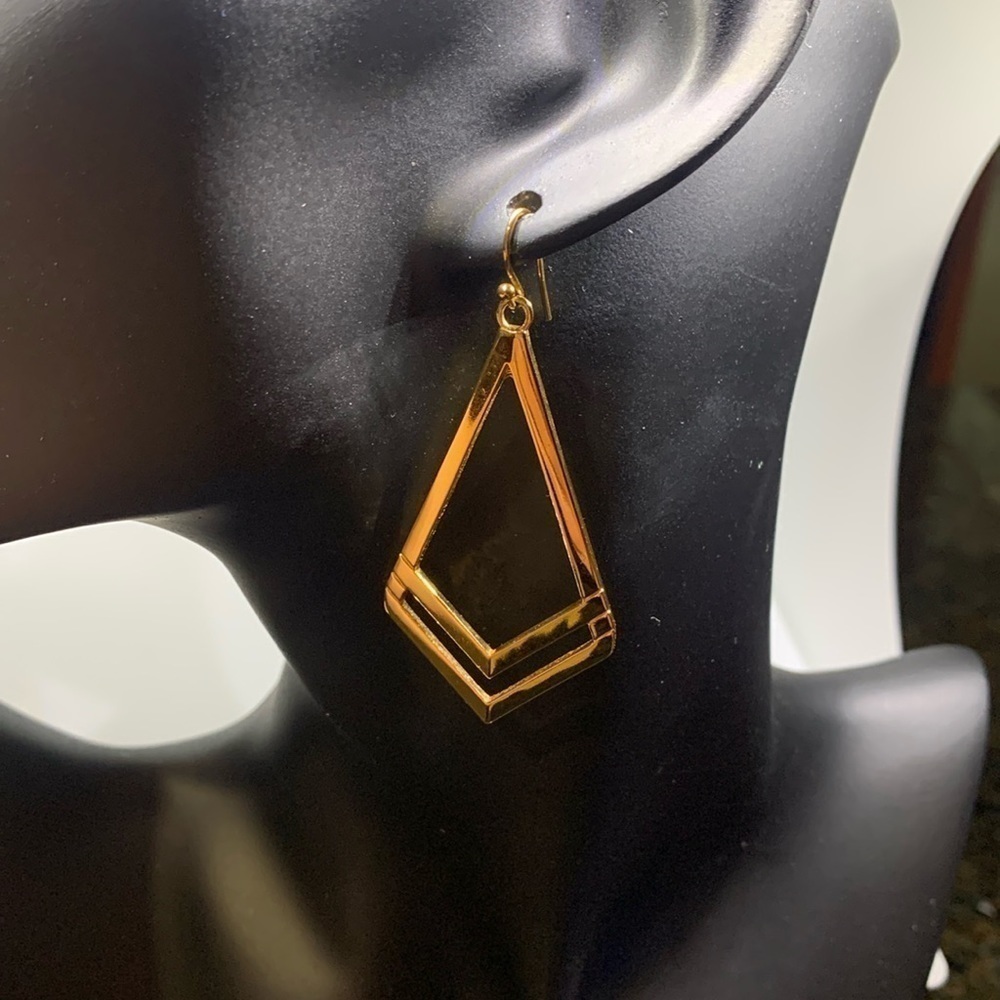 Gold tone dangling earrings.